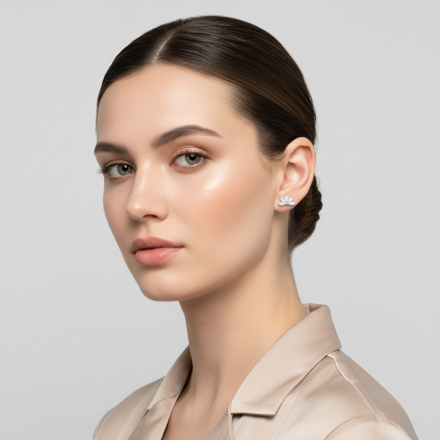 Melchior Jewellery geometric opal flower earrings worn by woman with sleek hair and neutral blouse