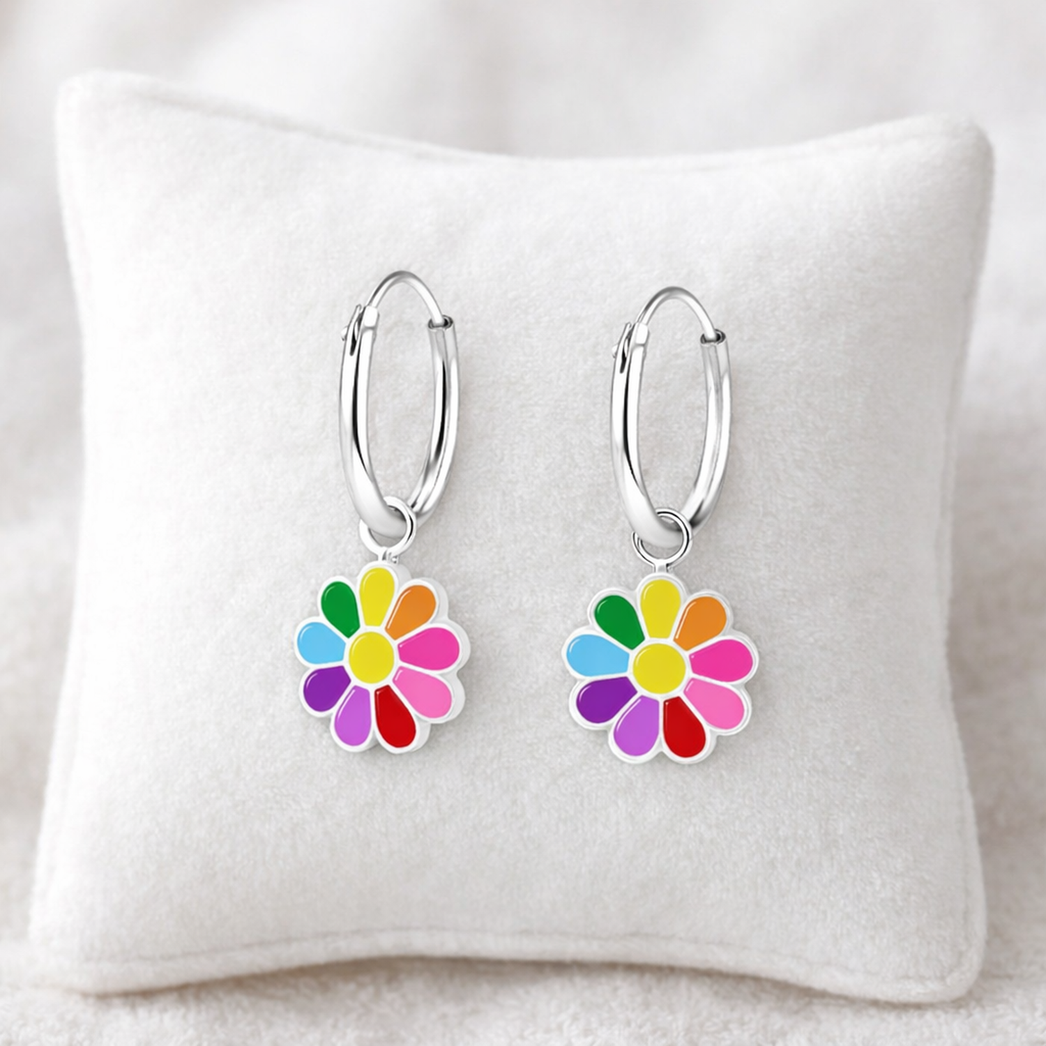 Melchior Jewellery girls silver flower hoop earrings with colourful flower charms on white cushion