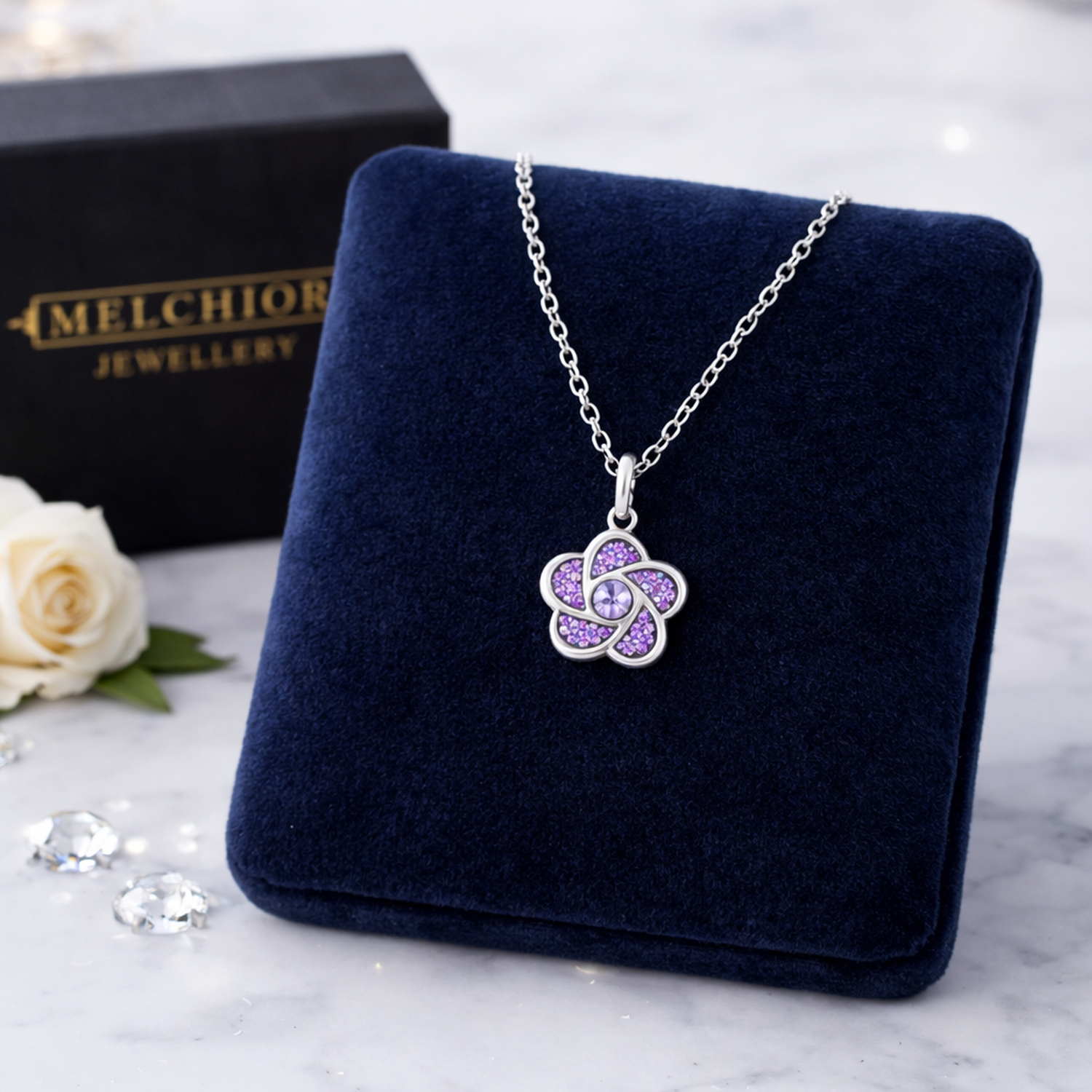 Melchior Jewellery girls sparkly purple necklace with flower pendant on silver chain displayed on velvet stand