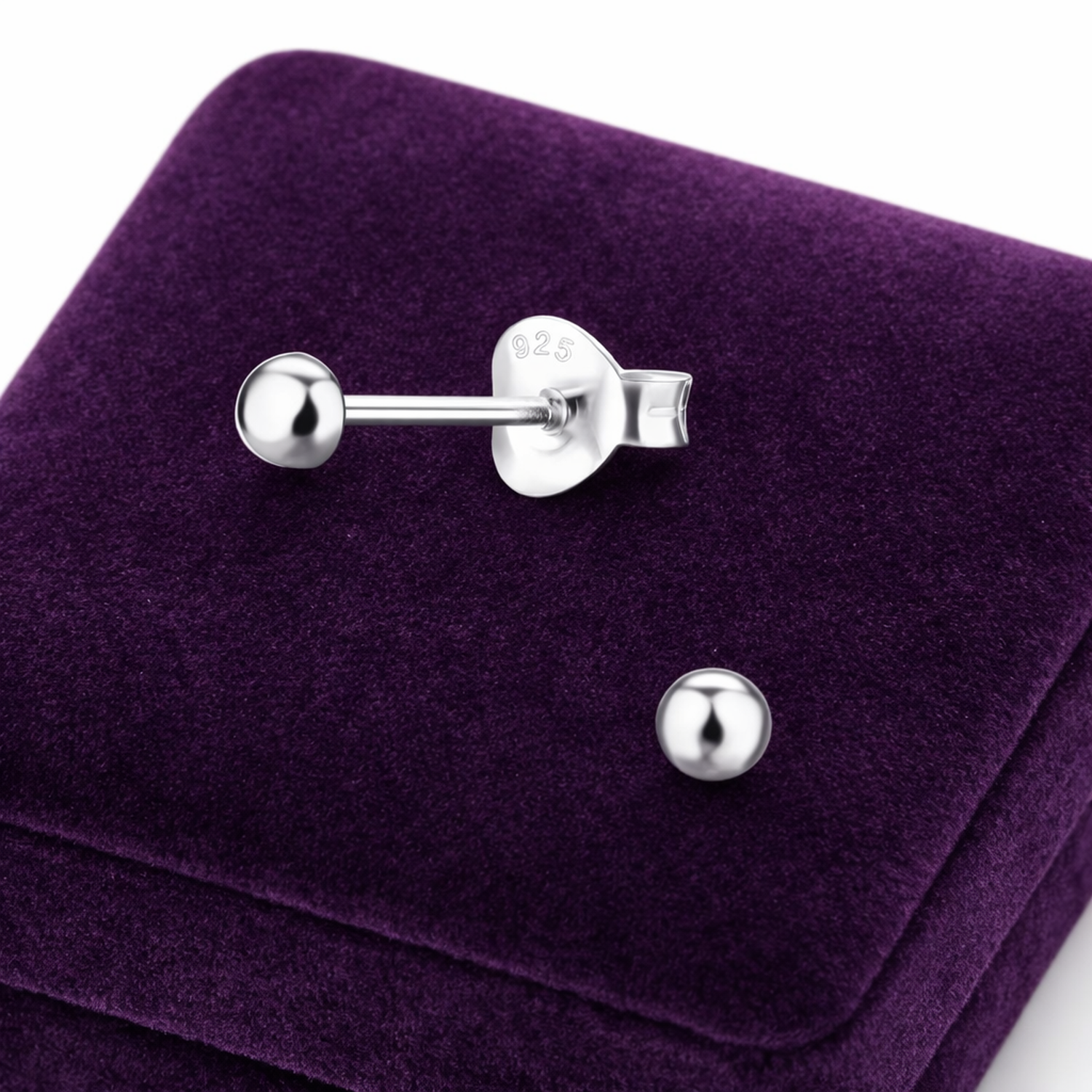 Melchior Jewellery half ball stud earrings sterling silver displayed on purple velvet box
