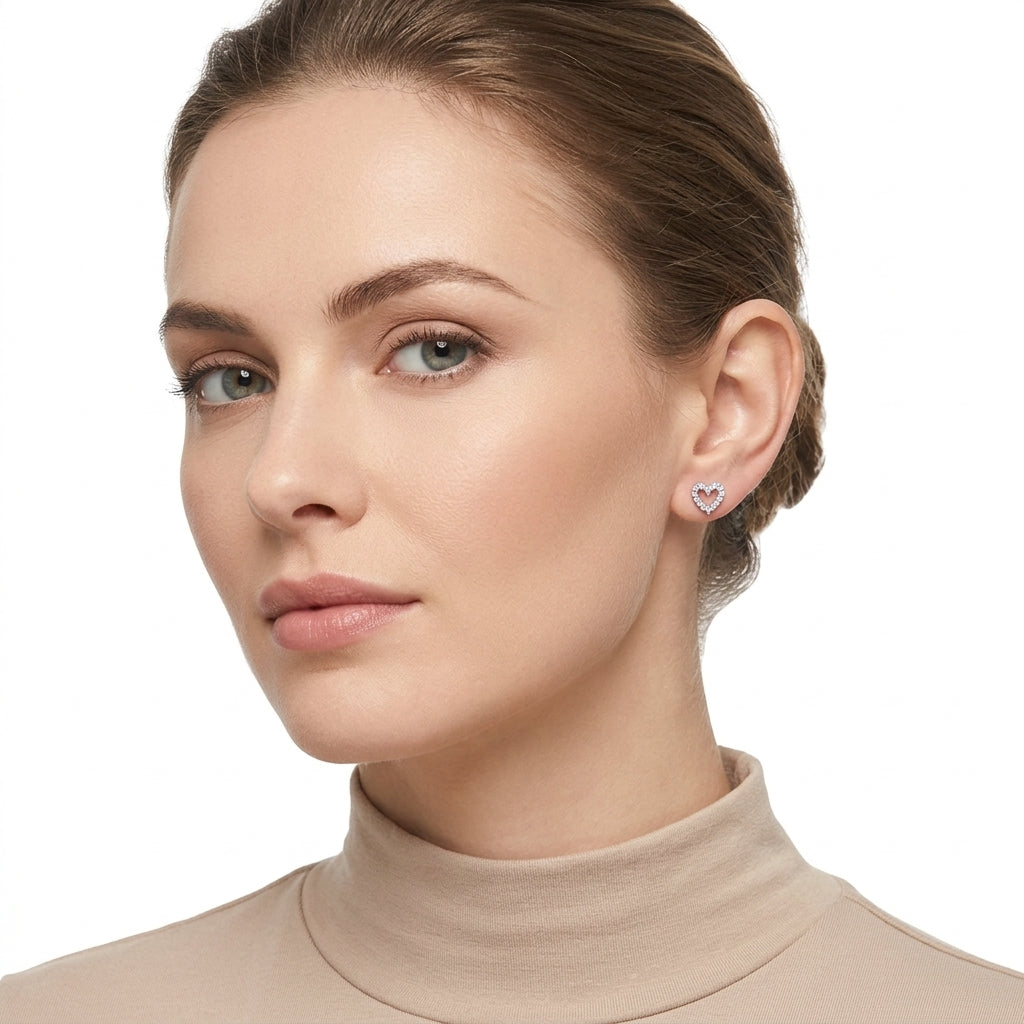 Melchior Jewellery silver heart stud earrings worn by woman with light skin and brown hair