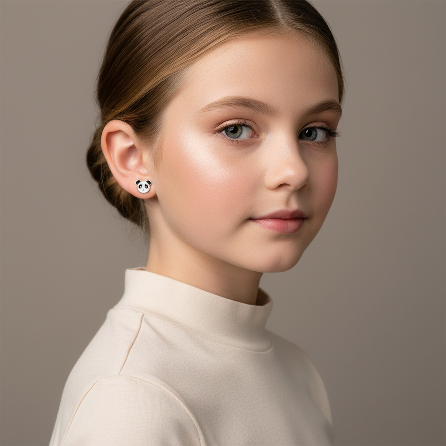 Young girl wearing hypoallergenic kids panda bear studs by Melchior Jewellery in white and black