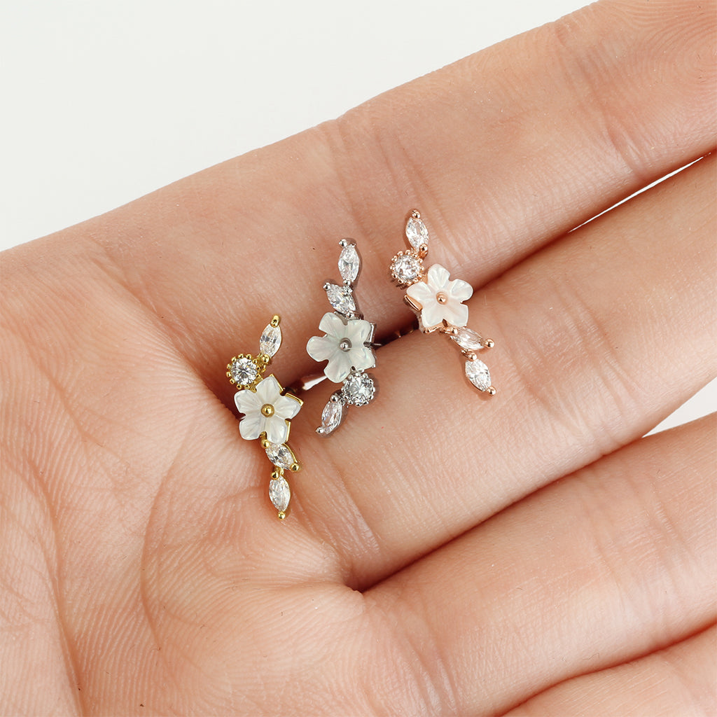 Melchior Jewellery cartilage stud with mother of pearl floral trio in gold silver and rose gold on a hand