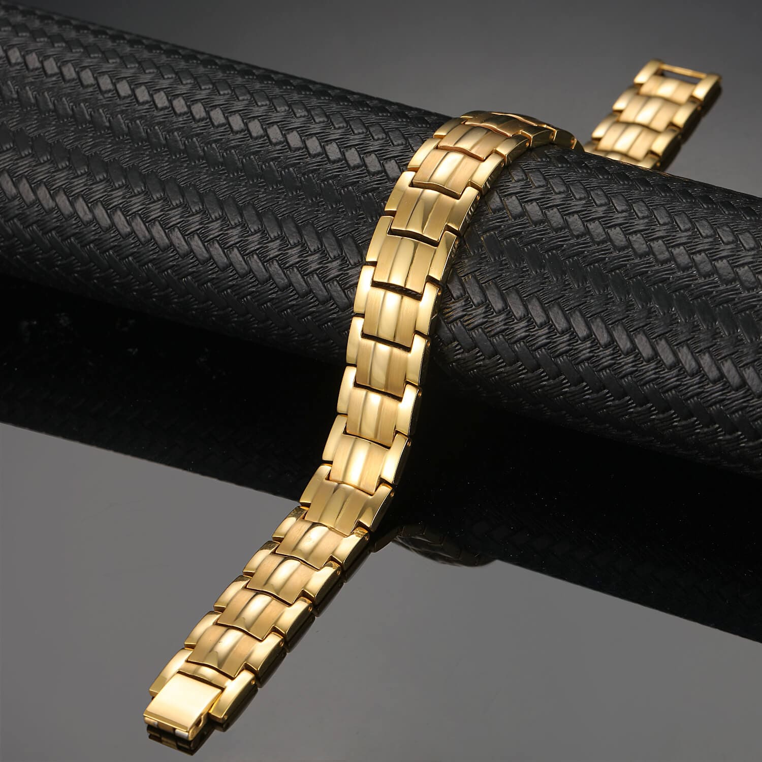 Melchior Jewellery gold titanium magnetic therapy bracelet with polished rectangular links on black display