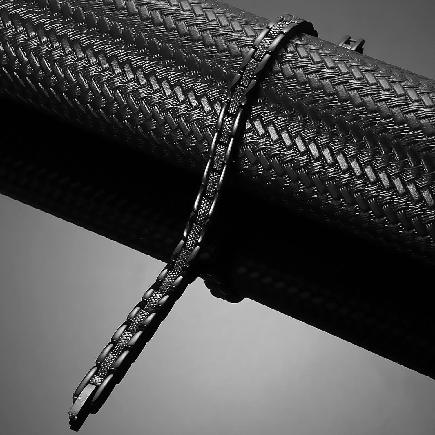 Melchior Jewellery ladies black titanium magnetic bracelet with textured links draped on dark prop