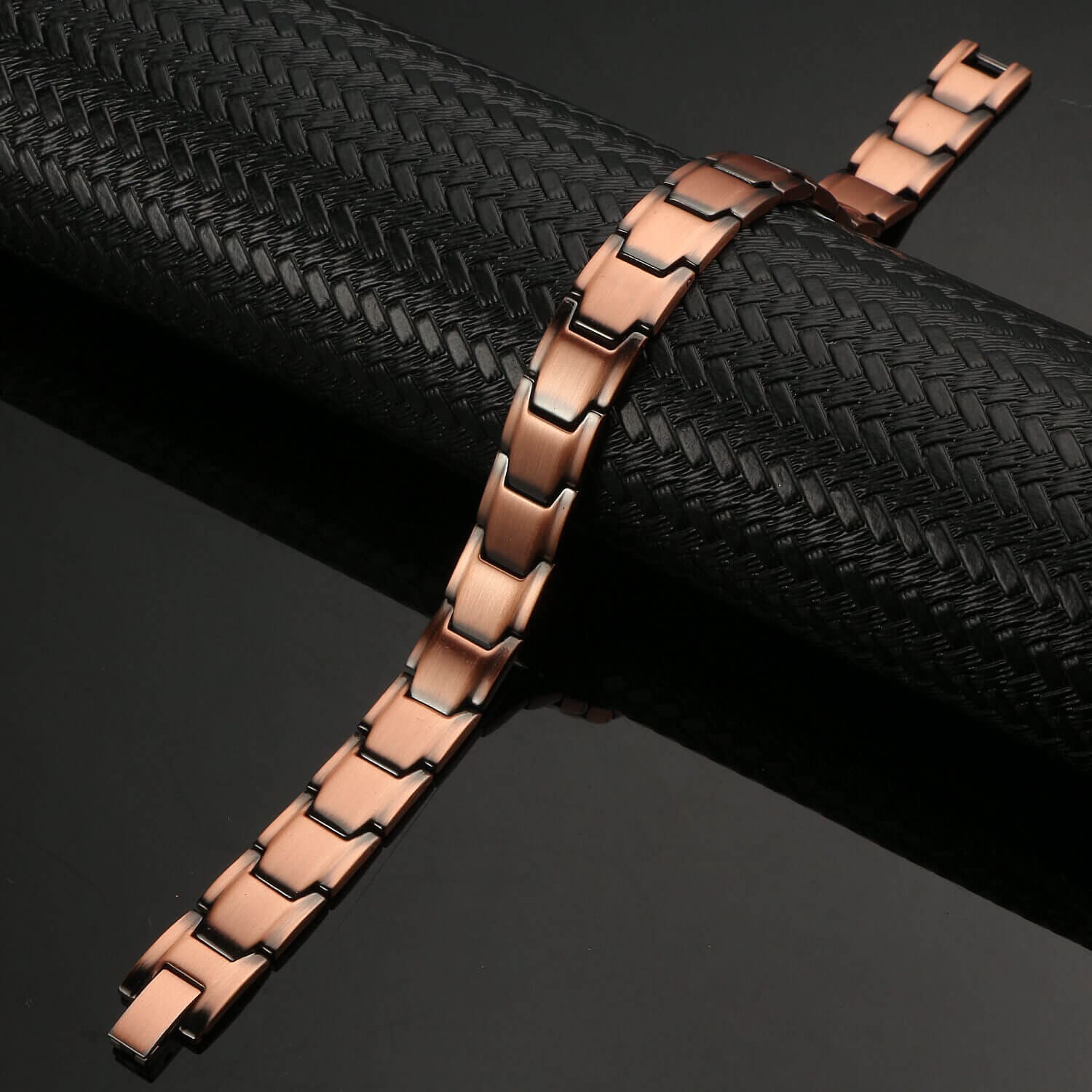 Melchior Jewellery rose gold link bracelet on black background, powerful energy healing bracelet for men