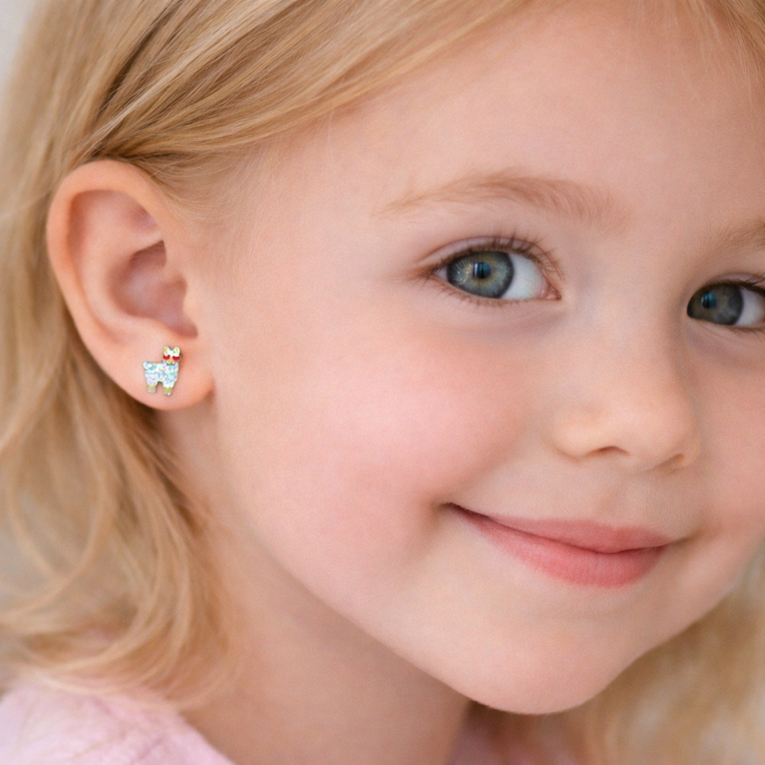 Melchior Jewellery kids glitter llama stud earrings worn by child with blonde hair and blue eyes