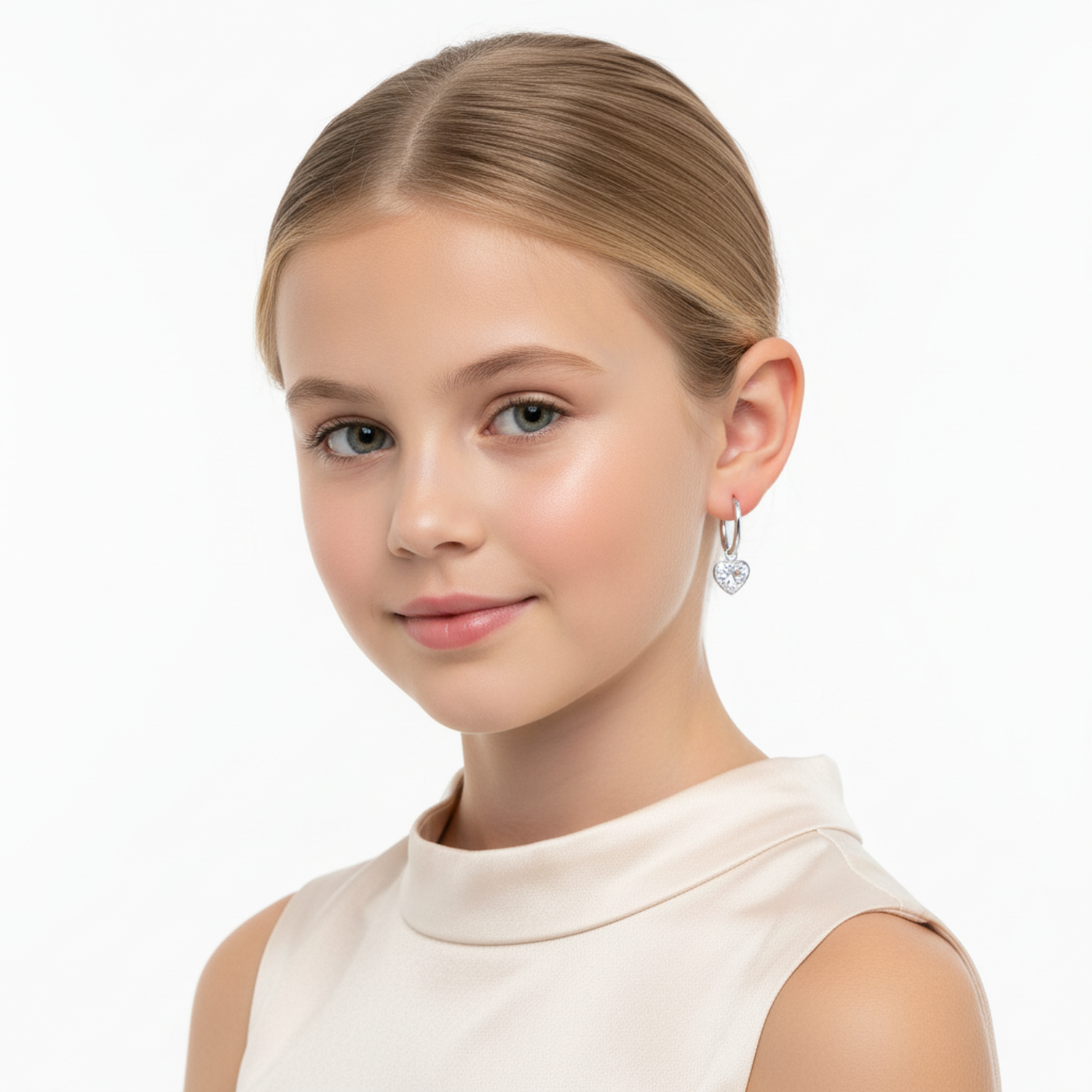 Young girl wearing kids heart CZ earrings hypoallergenic from Melchior Jewellery against white background