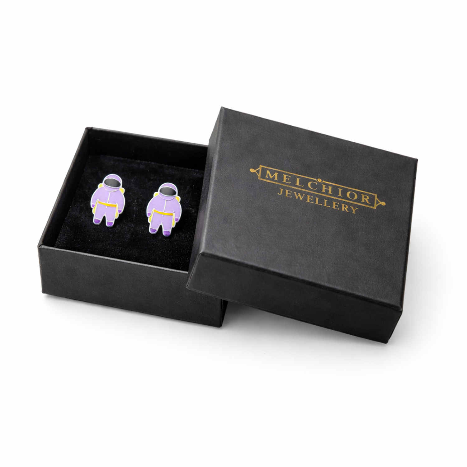 Kids hypoallergenic astronaut stud earrings in purple displayed in Melchior Jewellery black gift box