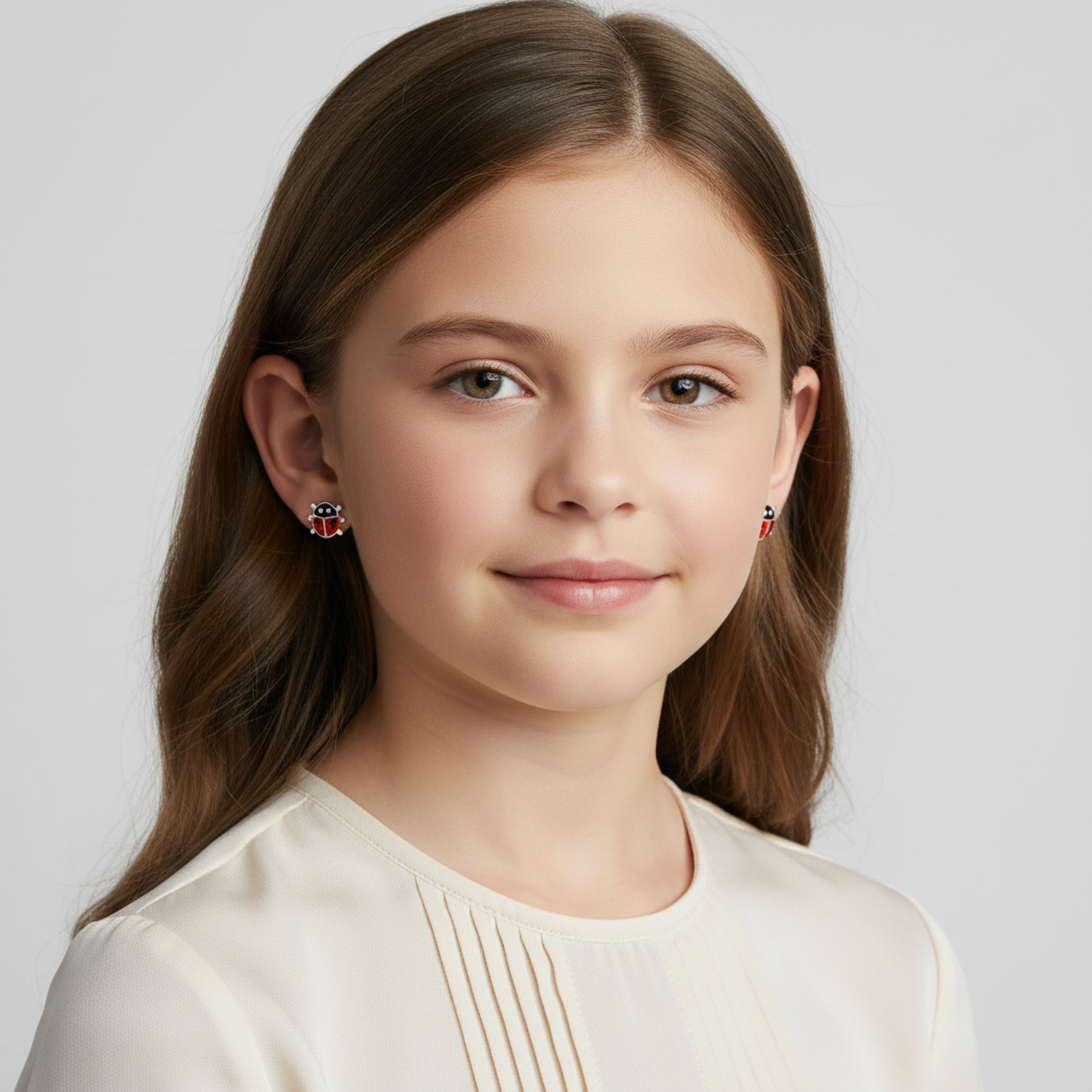 Melchior Jewellery kids silver ladybird screw back studs worn by young girl with brown hair