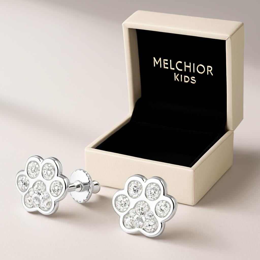 Kids sterling silver paw earrings with sparkling stones by Melchior Jewellery in an open cream gift box