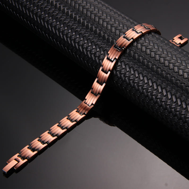 Ladies slim copper magnetic bracelet by Melchior Jewellery displayed on textured black surface