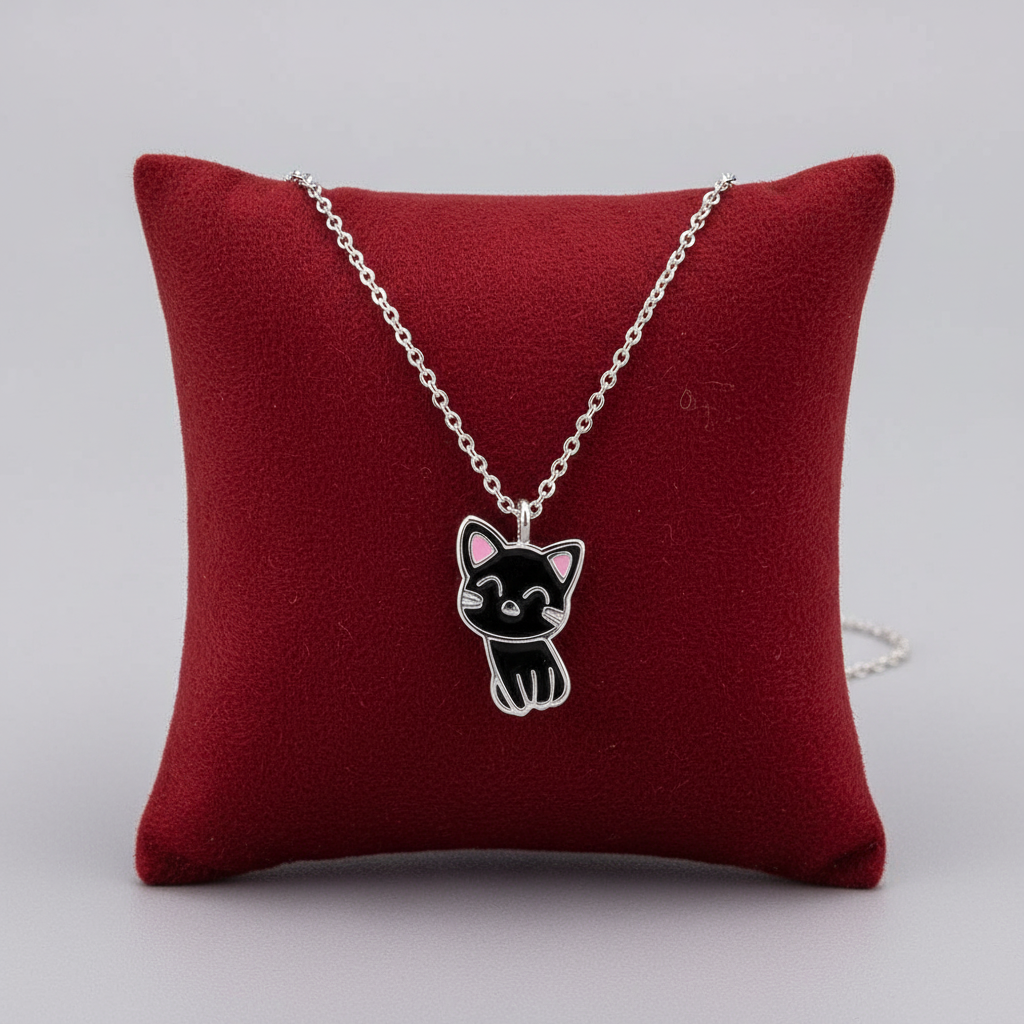 Melchior Jewellery lucky cat necklace for kids with silver chain and black cat pendant on red cushion