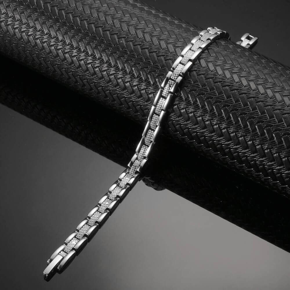 Melchior Jewellery silver stainless steel link magnetic health bracelet for woman on black textured background