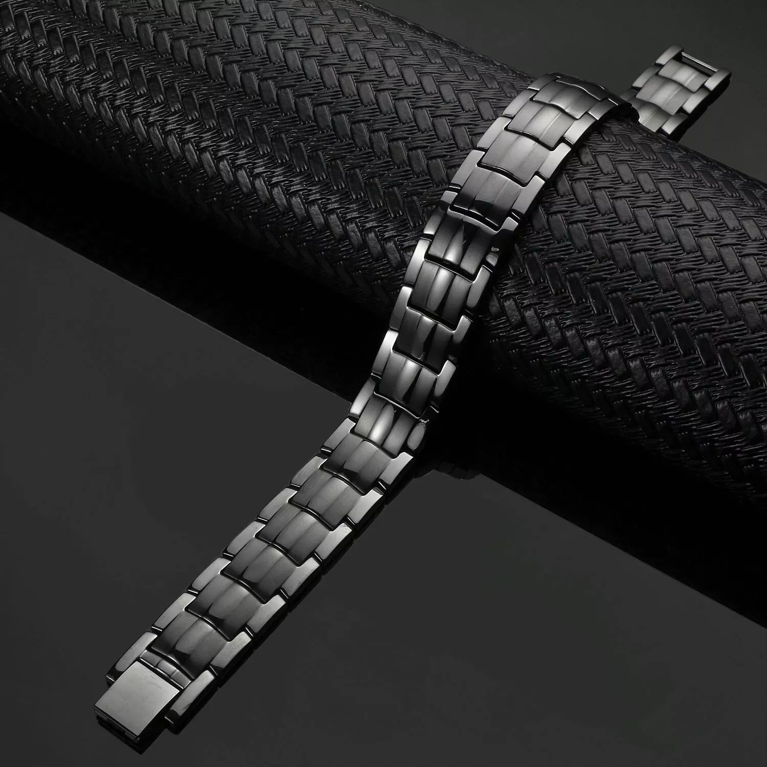 Melchior Jewellery mens gun metal titanium bracelet with brushed link design on black textured background