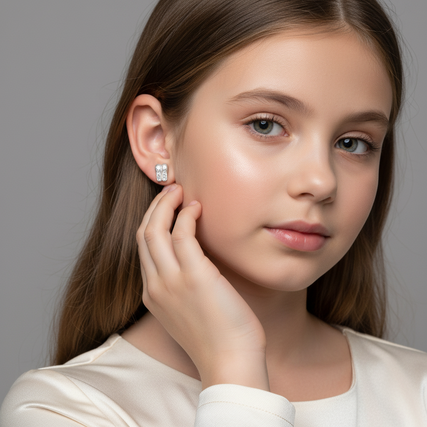 Melchior Jewellery ballet shoe stud earrings for kids worn by girl with long brown hair