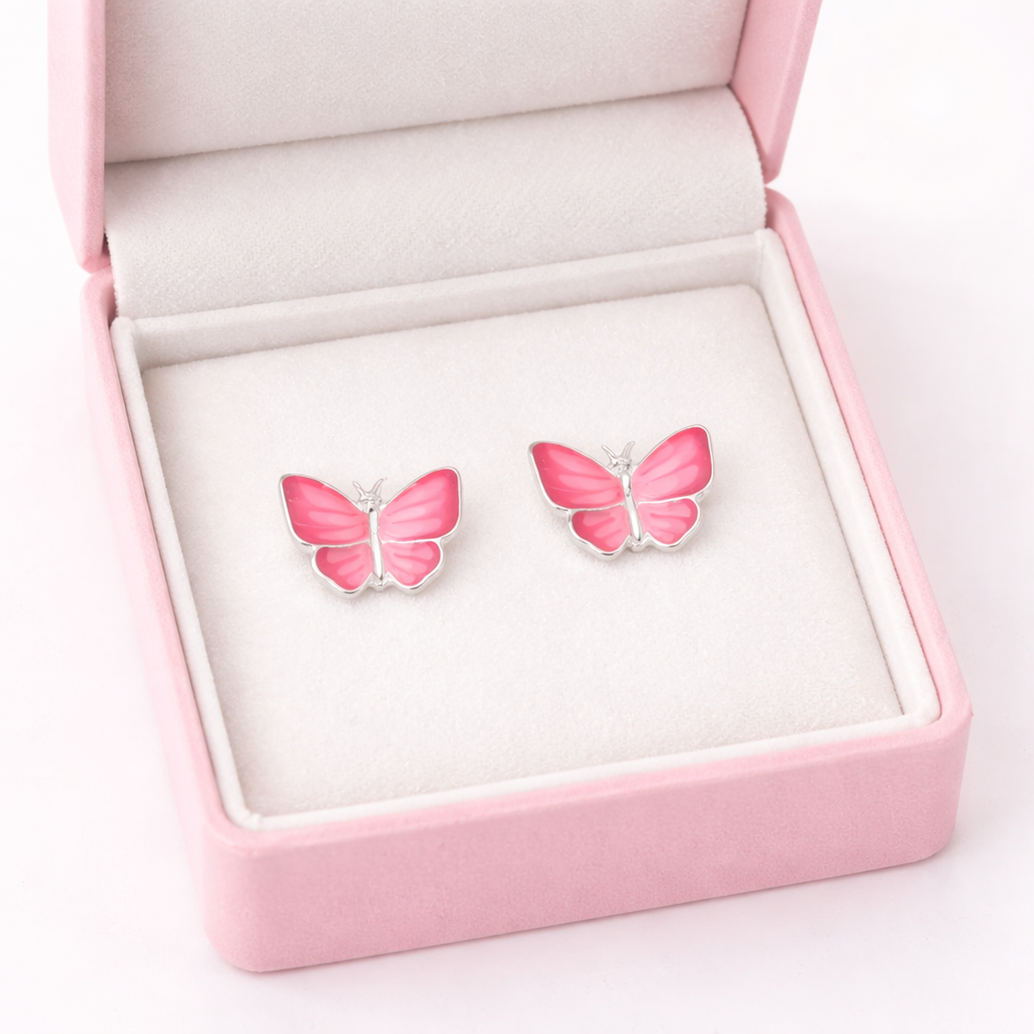 Melchior Jewellery pink butterfly stud earrings for kids displayed in a pink velvet jewellery box