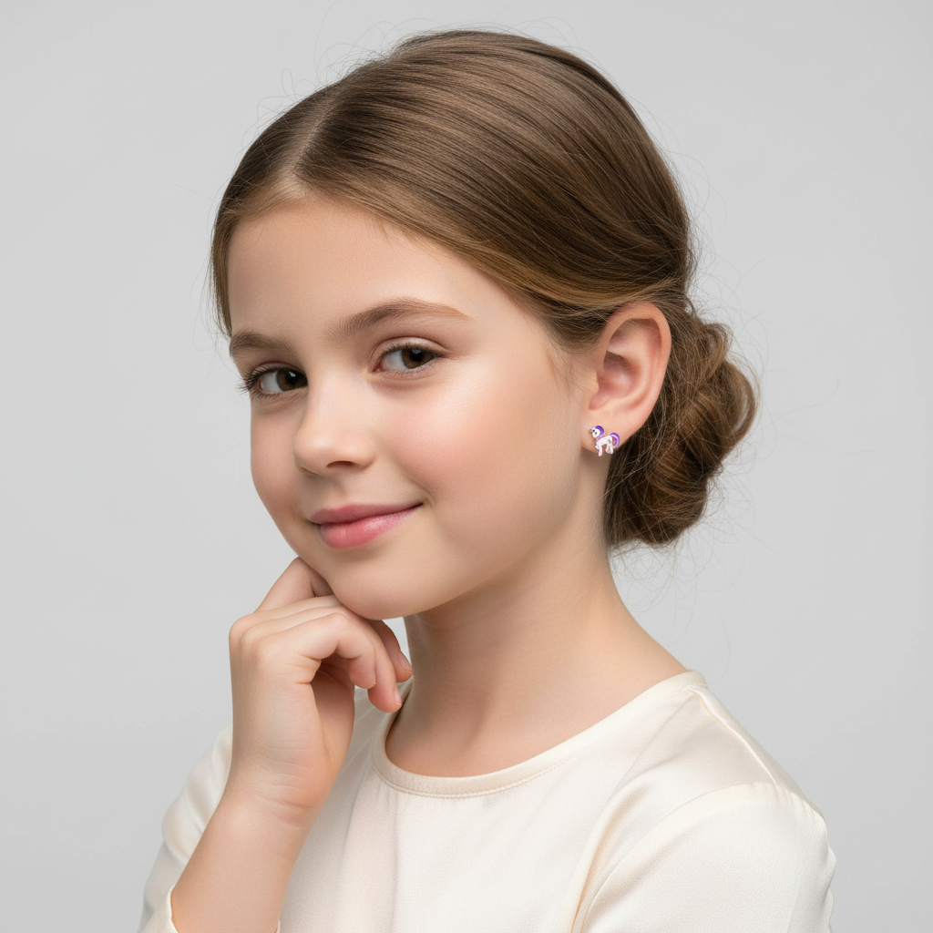 Young girl wearing Melchior Jewellery screw back unicorn earrings for kids with a white top