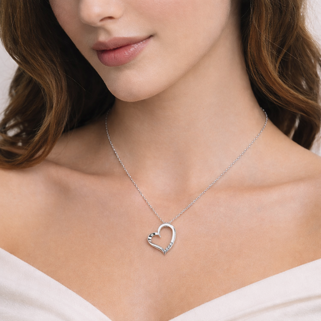 Melchior Jewellery silver open heart pendant necklace worn by woman with soft skin and brown hair