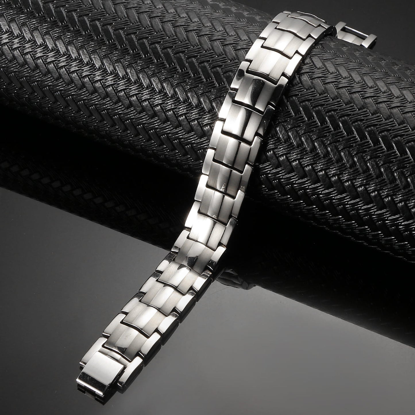 Melchior Jewellery silver titanium magnetic bracelet with sleek linked design on black textured surface