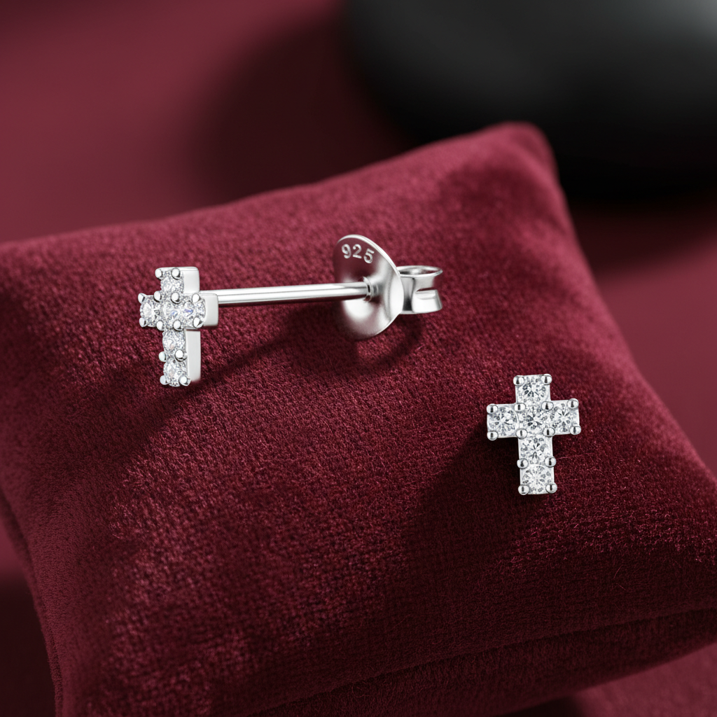Melchior Jewellery small cross earrings for girls with sparkling stones on burgundy cushion