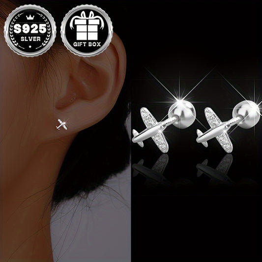 Small plane earrings for women made of 925 silver by Melchior Jewellery shown on ear and as pair