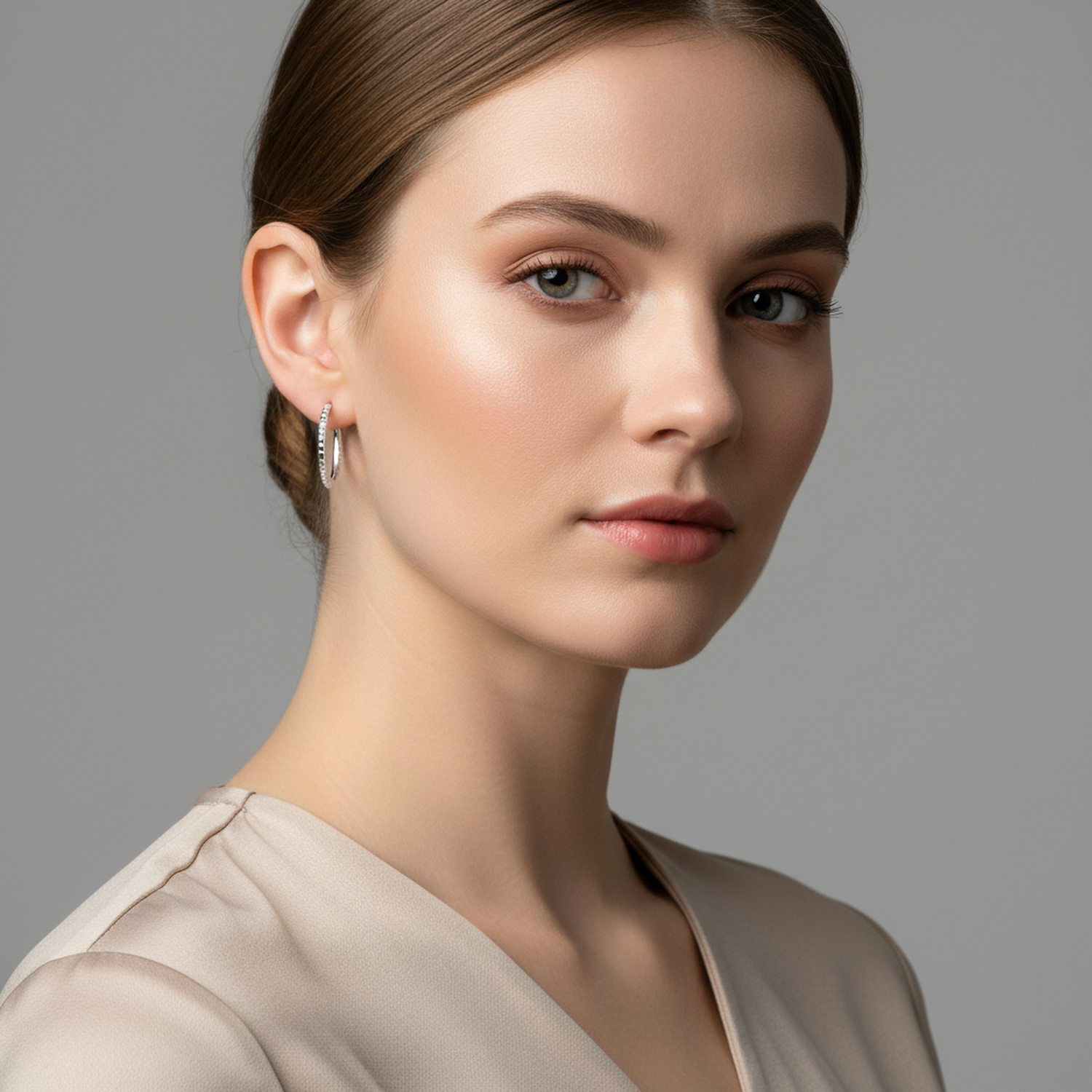 Melchior Jewellery sterling silver 18mm diamond cut hoop earrings worn by woman with neutral makeup