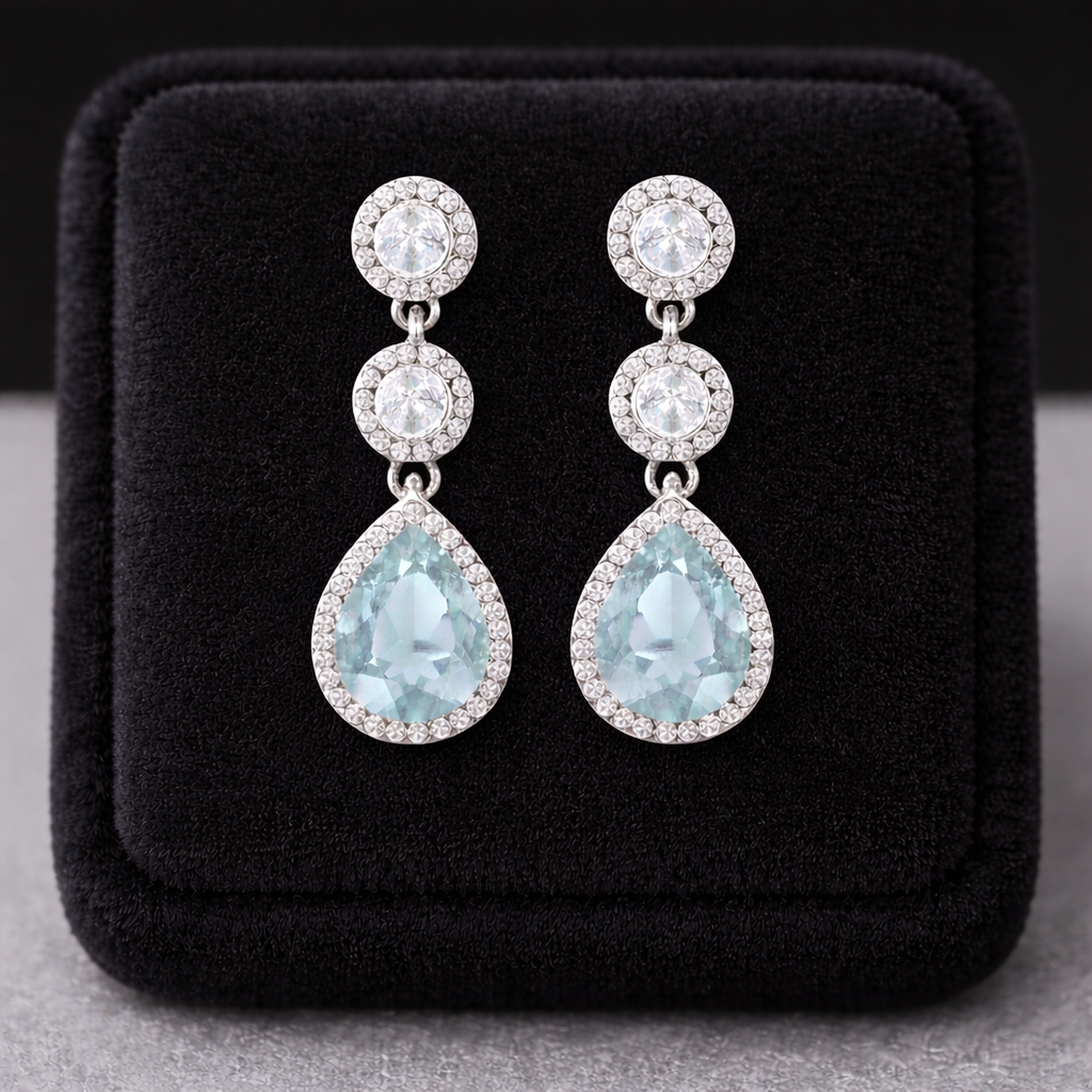 Sterling Silver Aquamarine Halo Drop Earrings by Melchior Jewellery displayed on black velvet