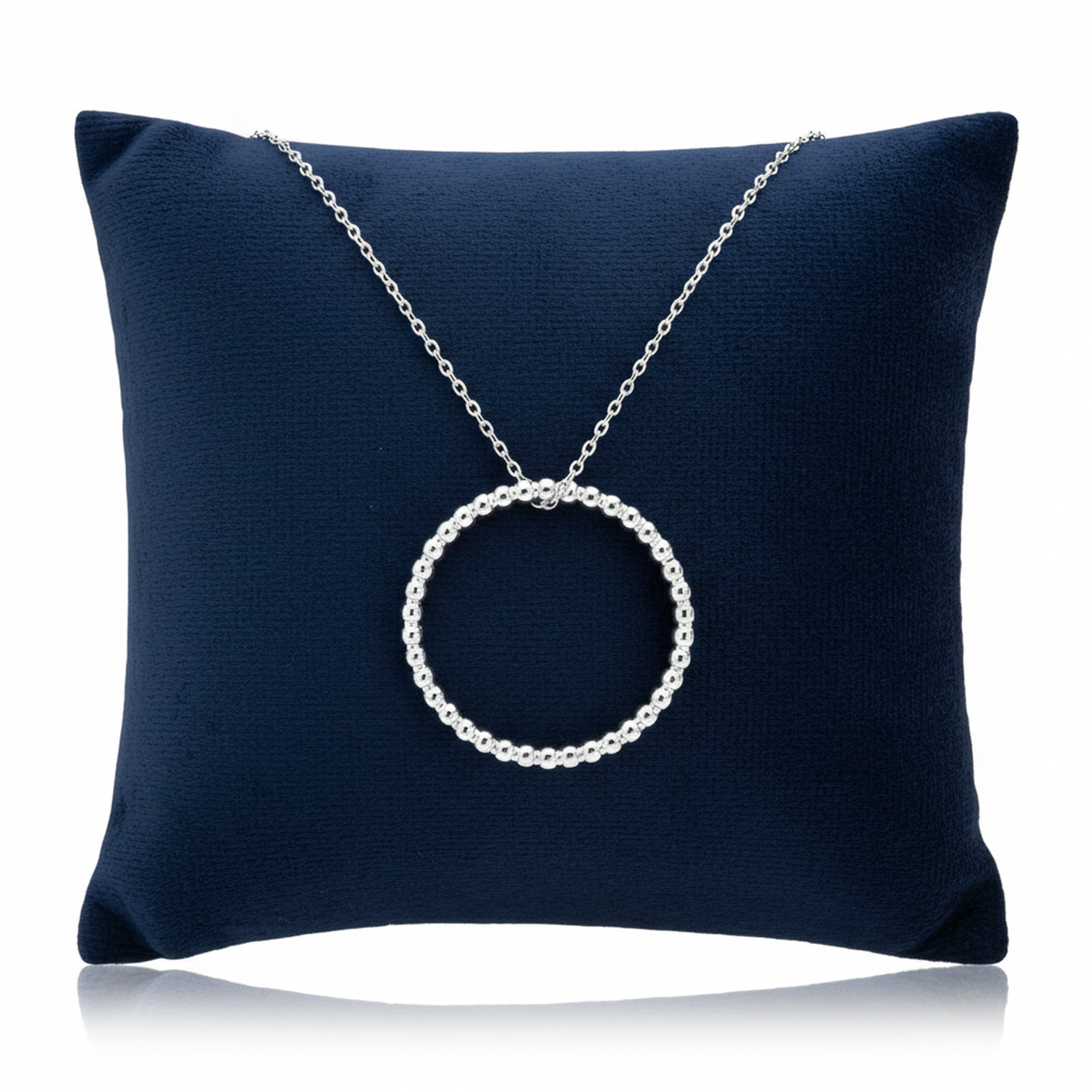 Sterling Silver Beaded Halo Necklace from Melchior Jewellery displayed on a dark blue cushion