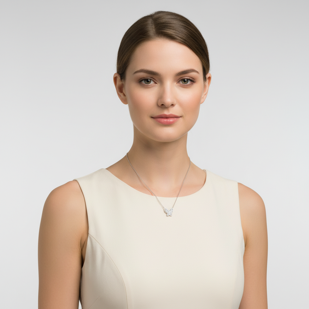 Melchior Jewellery sterling silver butterfly necklace worn by woman in cream dress