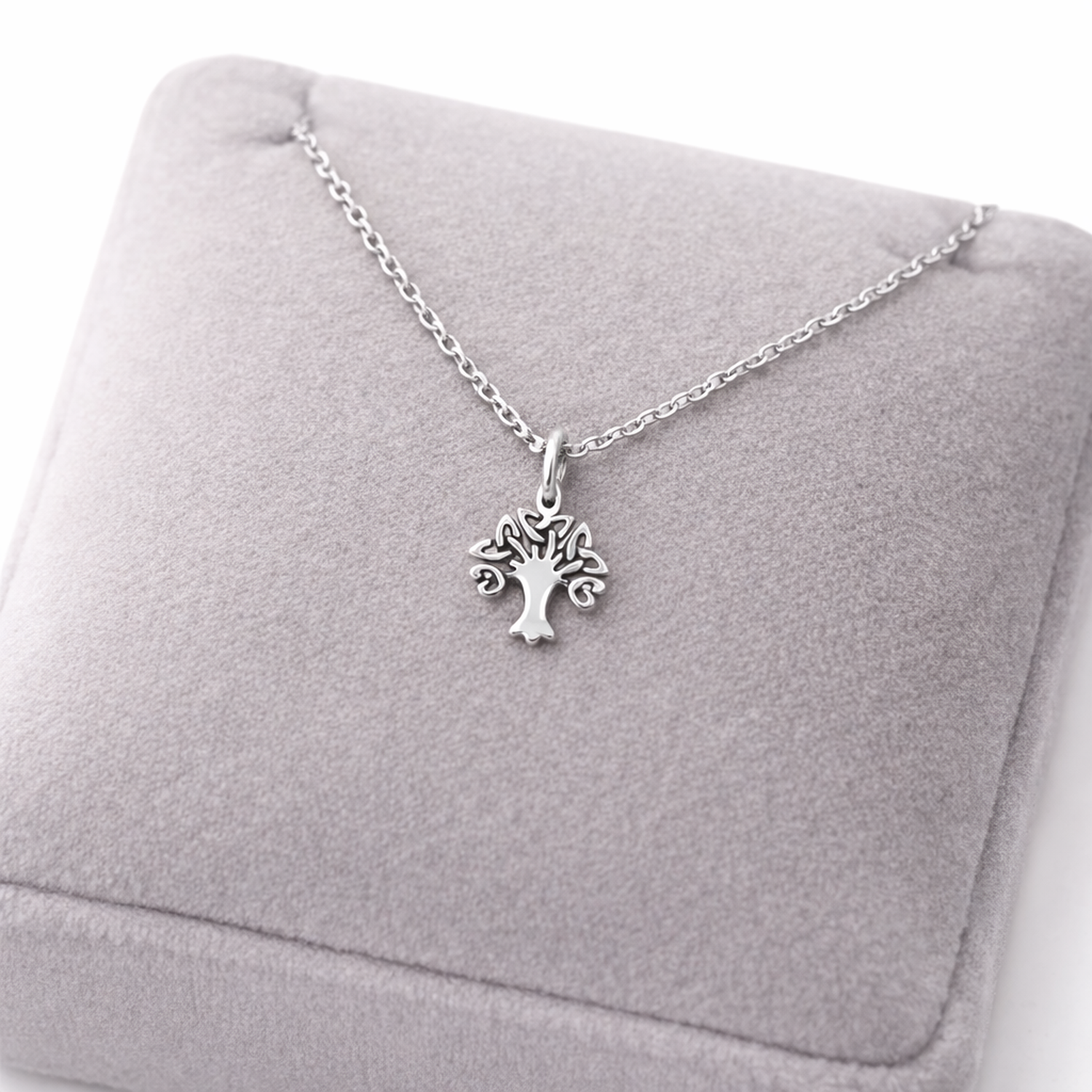 Sterling silver Celtic tree necklace by Melchior Jewellery displayed on grey cushion