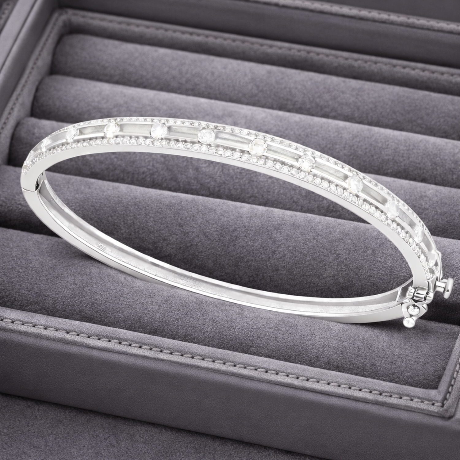 Melchior Jewellery sterling silver cubic zirconia bangle displayed on a grey velvet jewellery tray