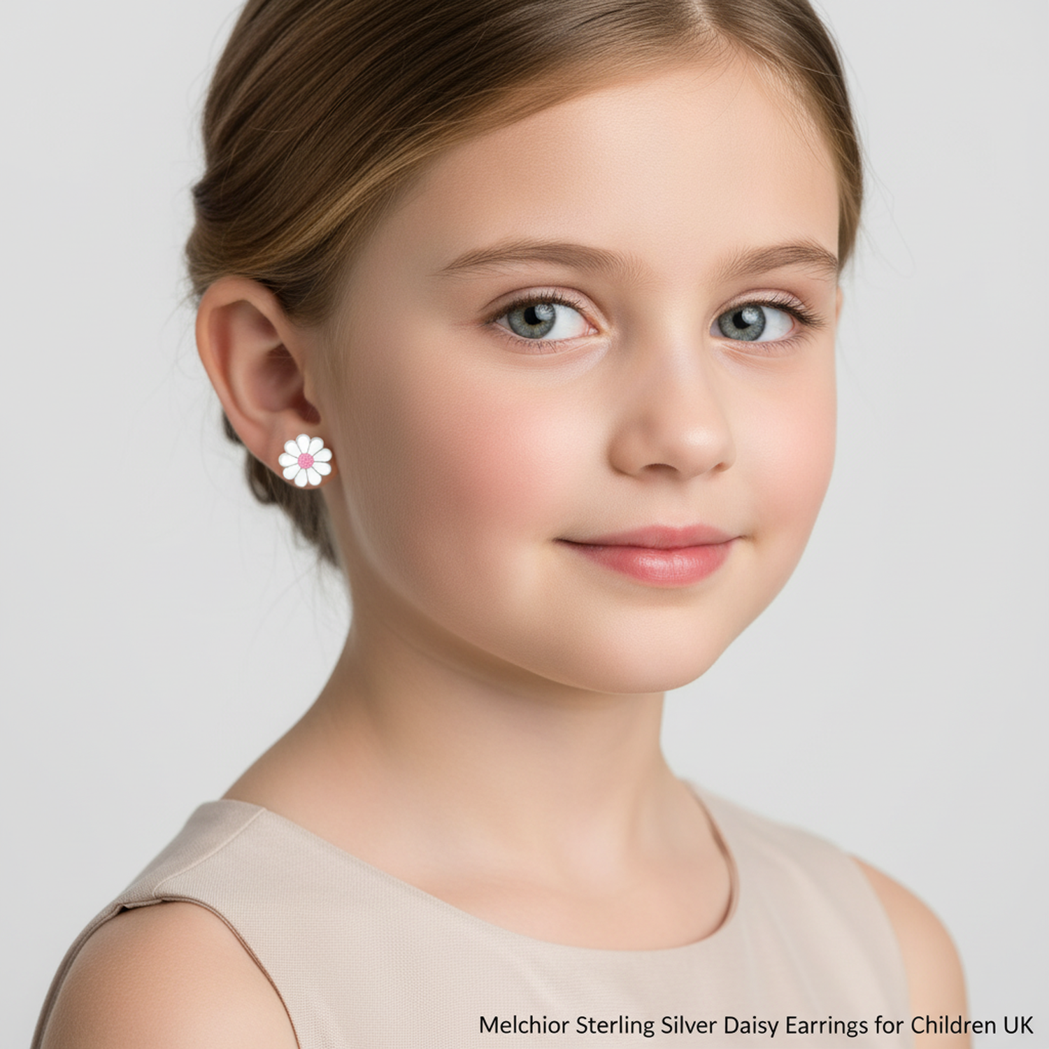 Girl wearing sterling silver daisy earrings for children UK by Melchior Jewellery