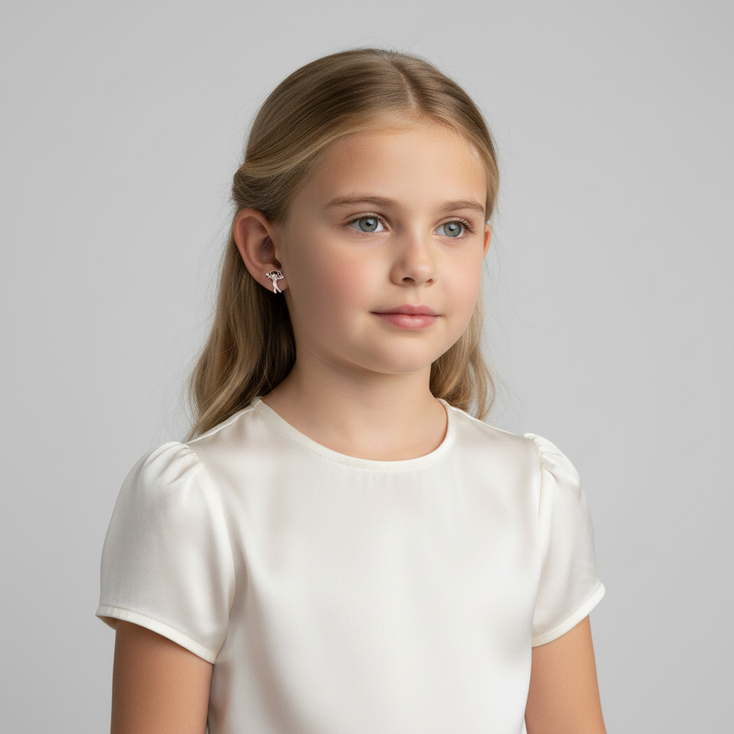 Sterling silver earrings for little girls worn by young girl in white top, handmade by Melchior Jewellery