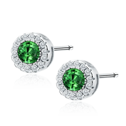 Melchior Jewellery sterling silver emerald stud earrings with surrounding clear stones on a black background