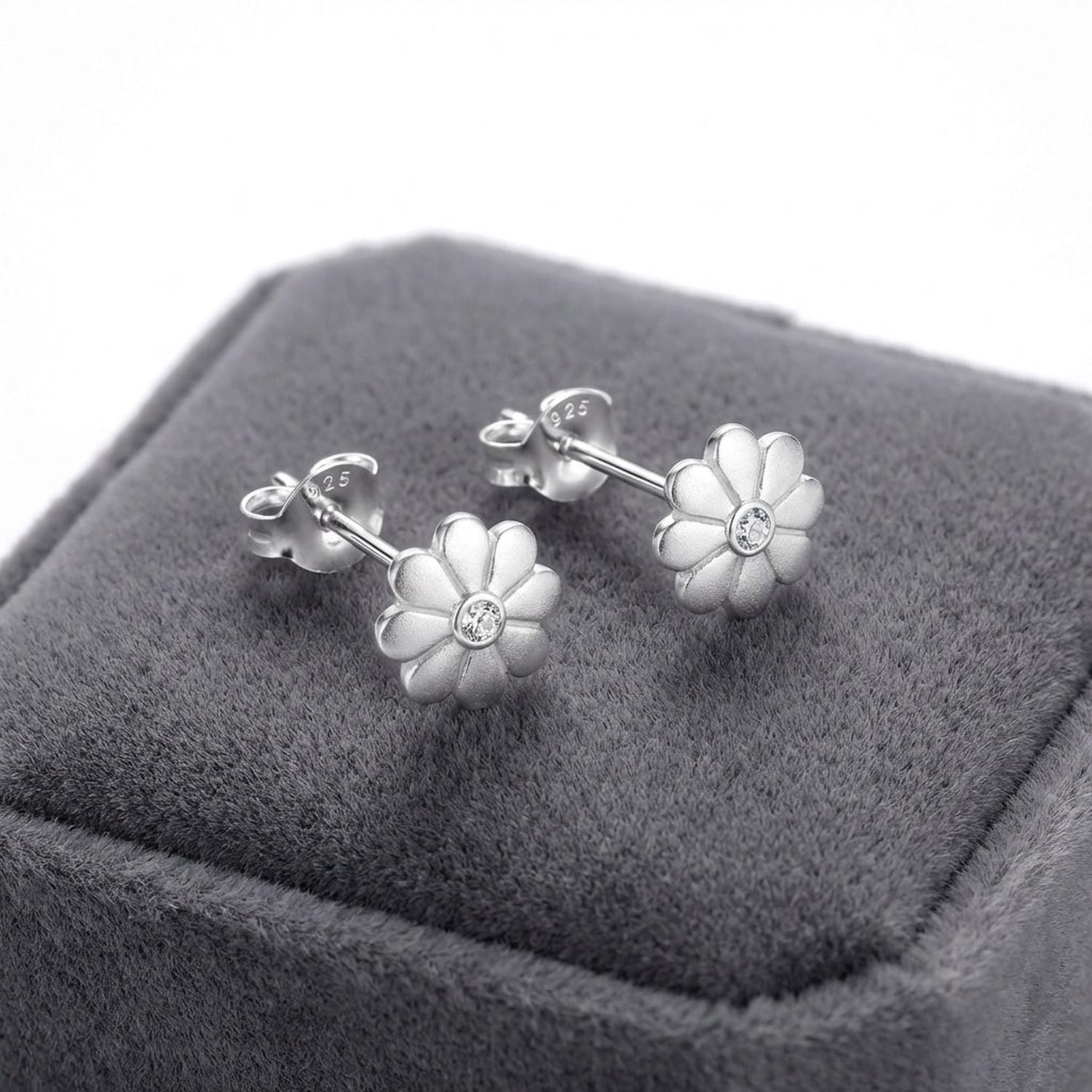 Sterling silver flower stud earrings for girls by Melchior Jewellery displayed on grey velvet box
