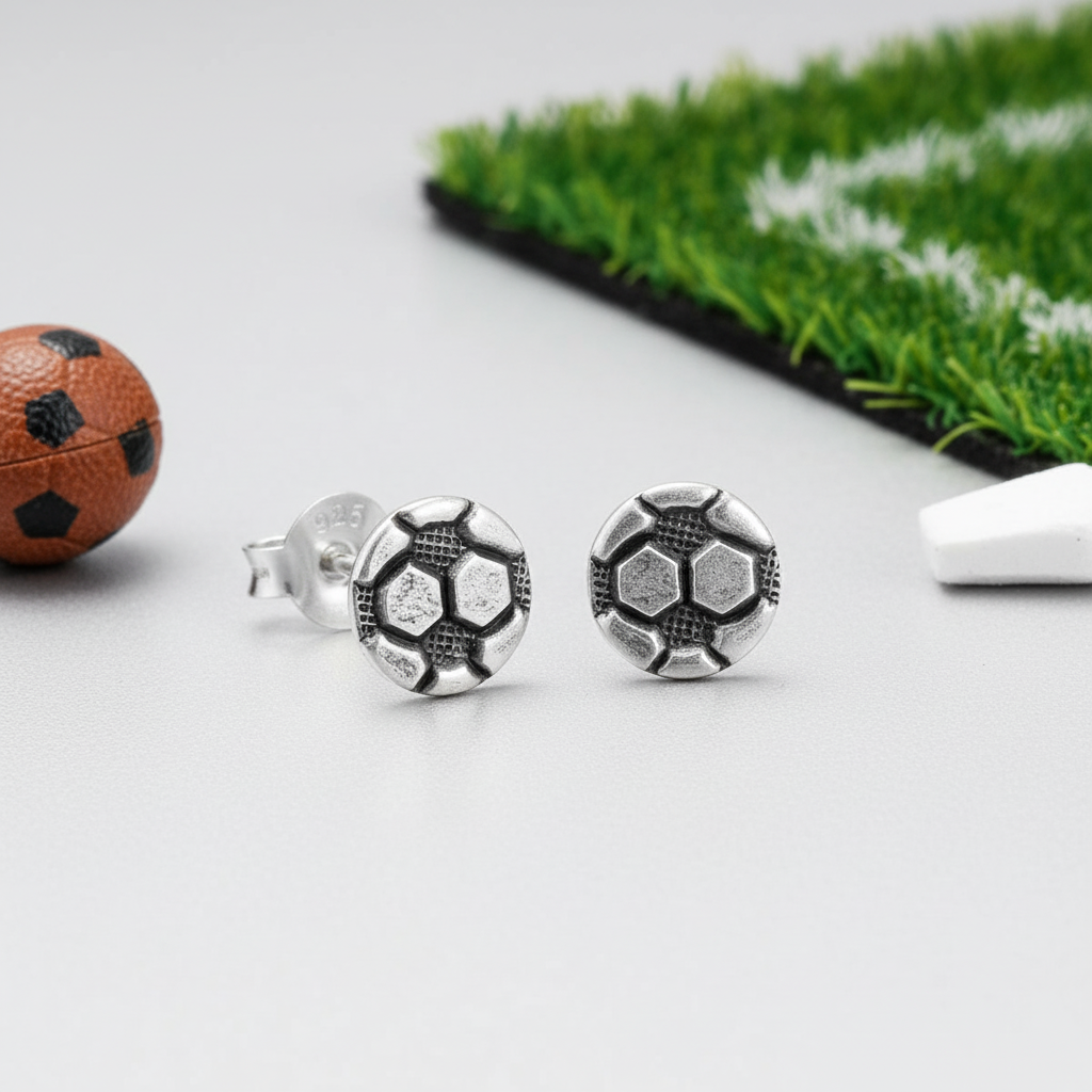 Melchior Jewellery sterling silver football stud earrings with detailed football design on grey background