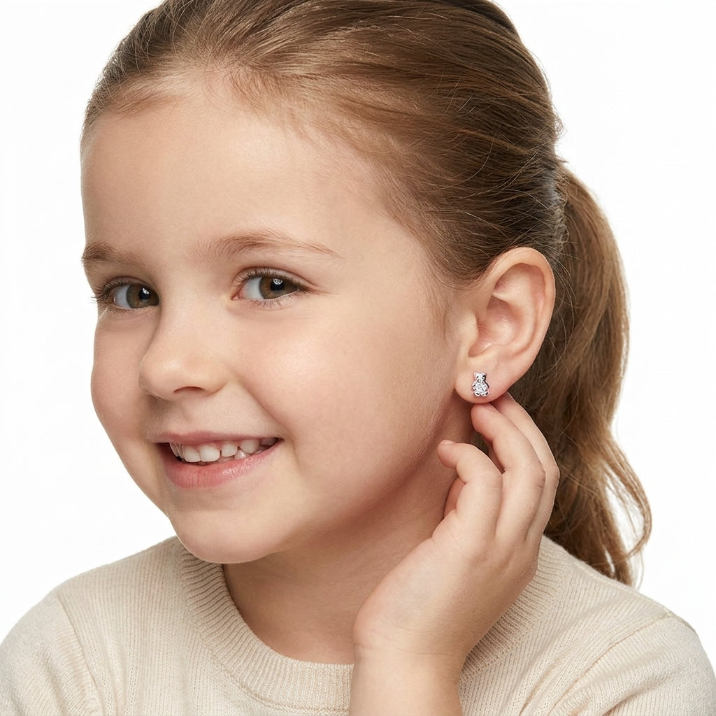 Young girl wearing sterling silver girls april birthstone stud earrings with clear sparkling stones by Melchior Jewellery