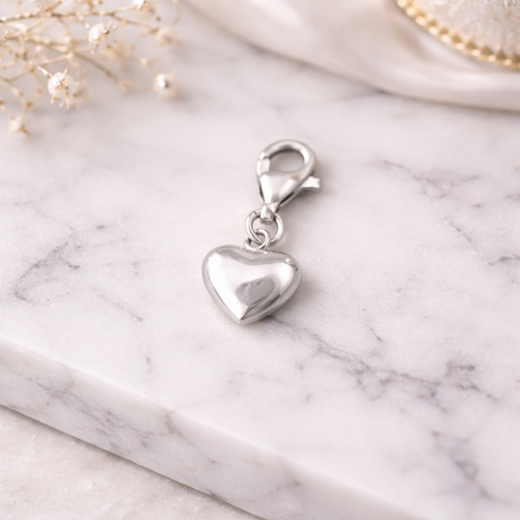 Melchior Jewellery sterling silver heart charm with smooth polished finish and lobster clasp on white marble surface