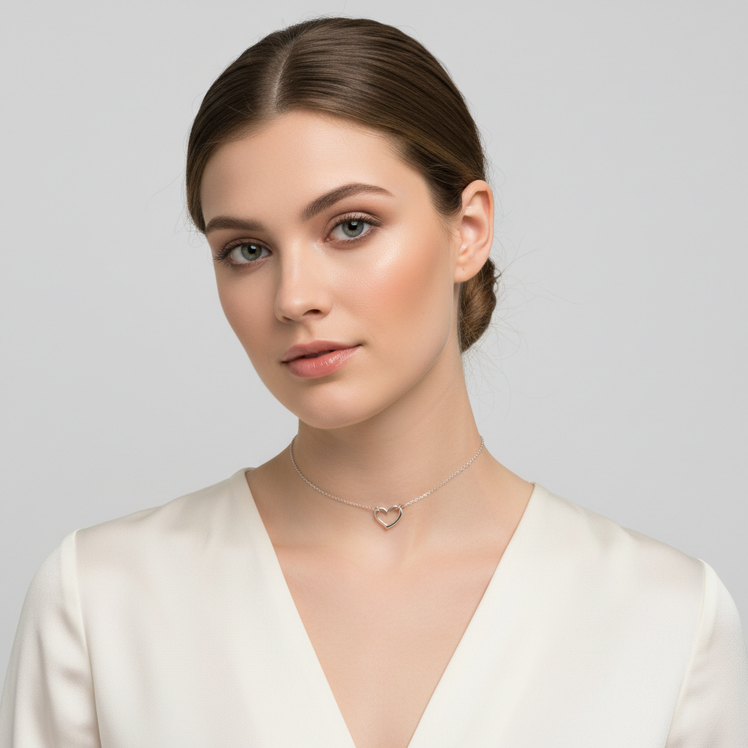 Melchior Jewellery sterling silver heart choker necklace worn by woman with neutral makeup and white blouse