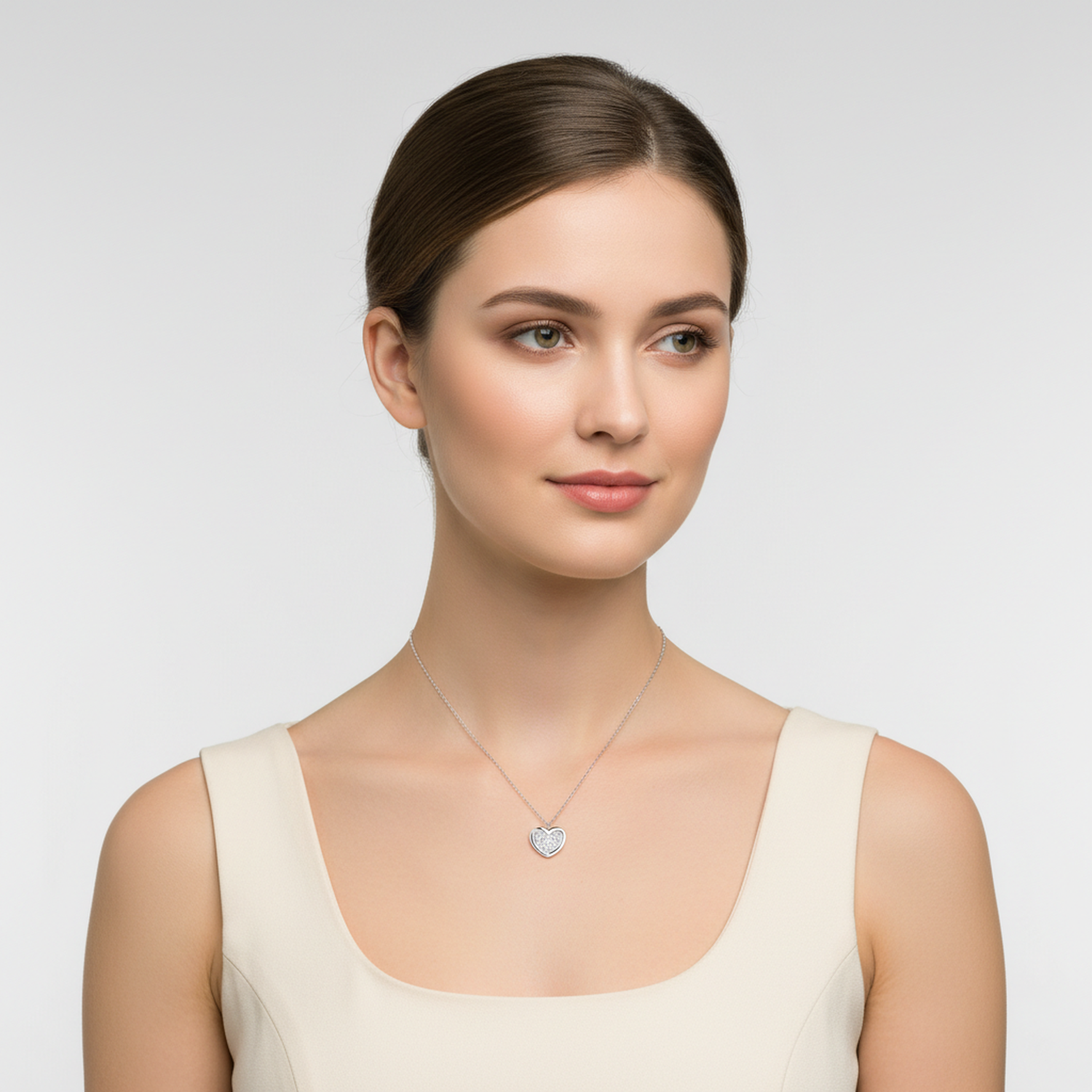 Sterling silver heart necklace for woman by Melchior Jewellery worn by woman with cream top