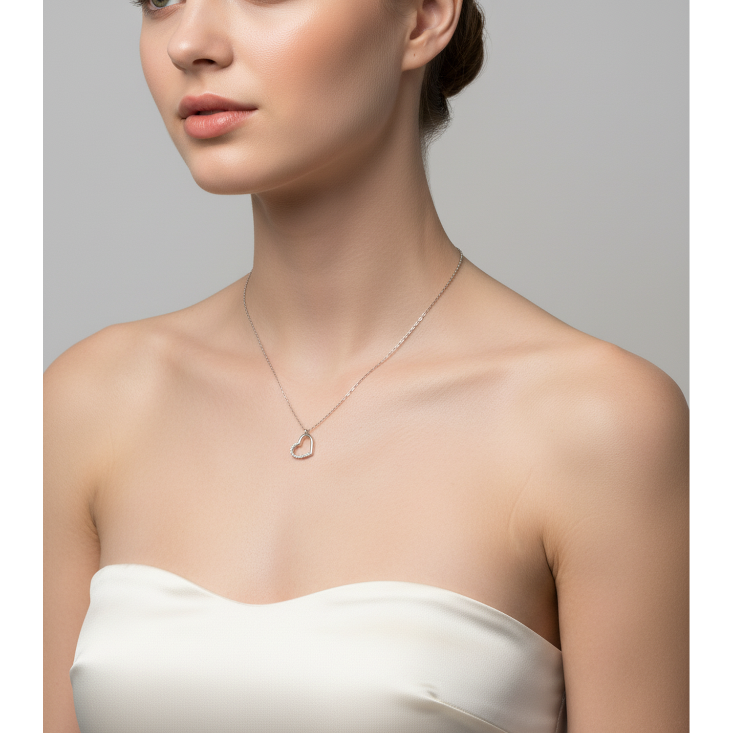 Melchior Jewellery sterling silver heart necklace for women with delicate chain on model wearing white strapless top