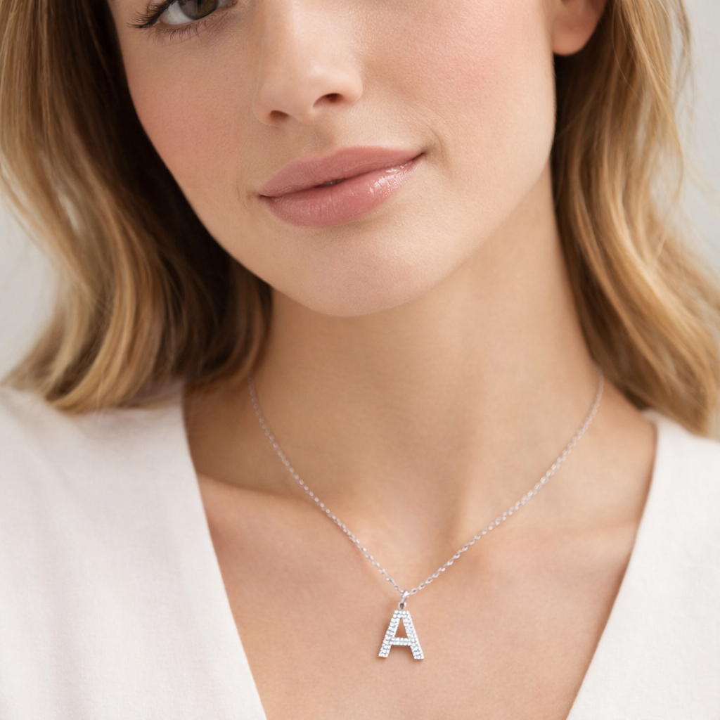 Melchior Jewellery sterling silver letter A jewellery necklace worn by woman with light top