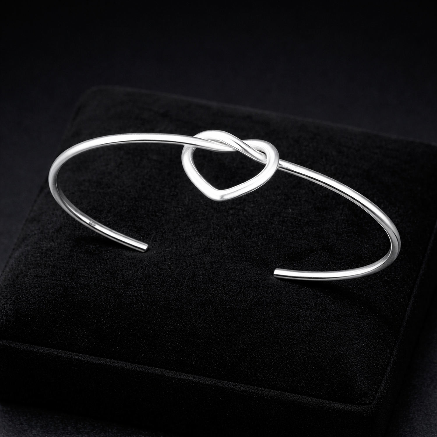 Melchior Jewellery sterling silver love knot bangle with heart design on black display