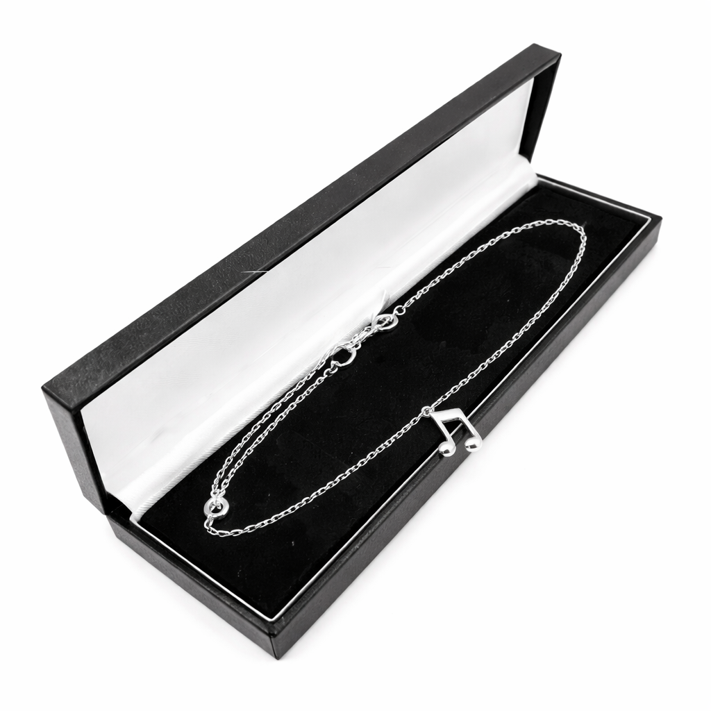 Sentiell sterling silver musical note charm bracelet displayed in black and white jewellery box
