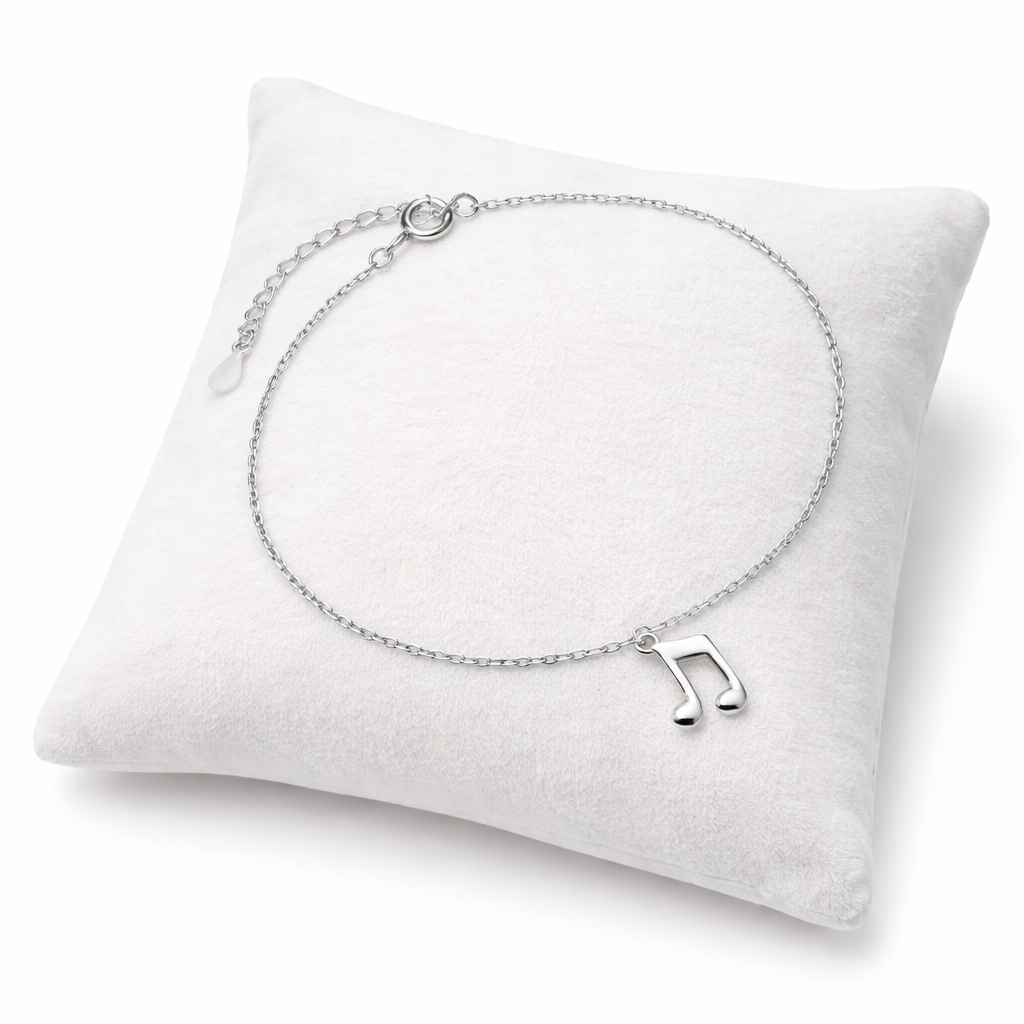 Sentiell sterling silver musical note charm bracelet displayed on a white cushion for women