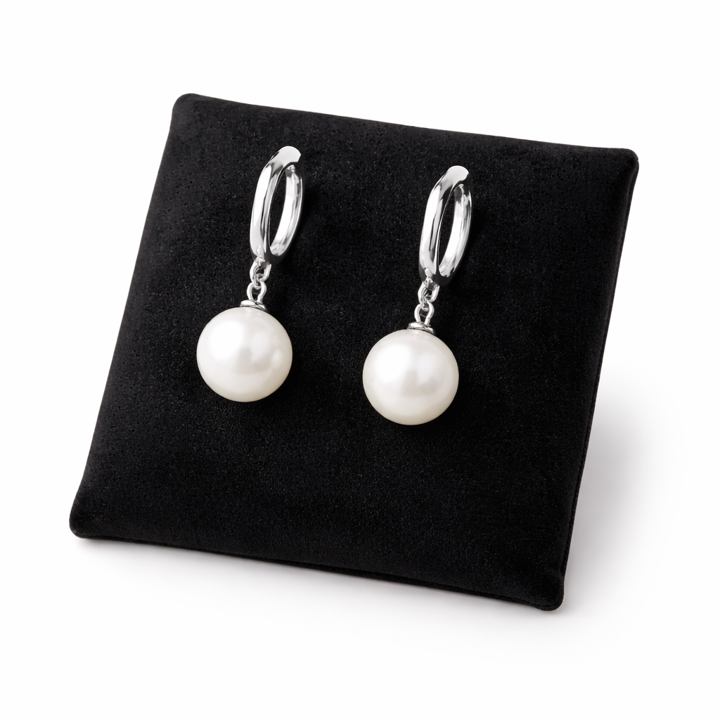Melchior Jewellery sterling silver pearl drop earrings displayed on black cushion