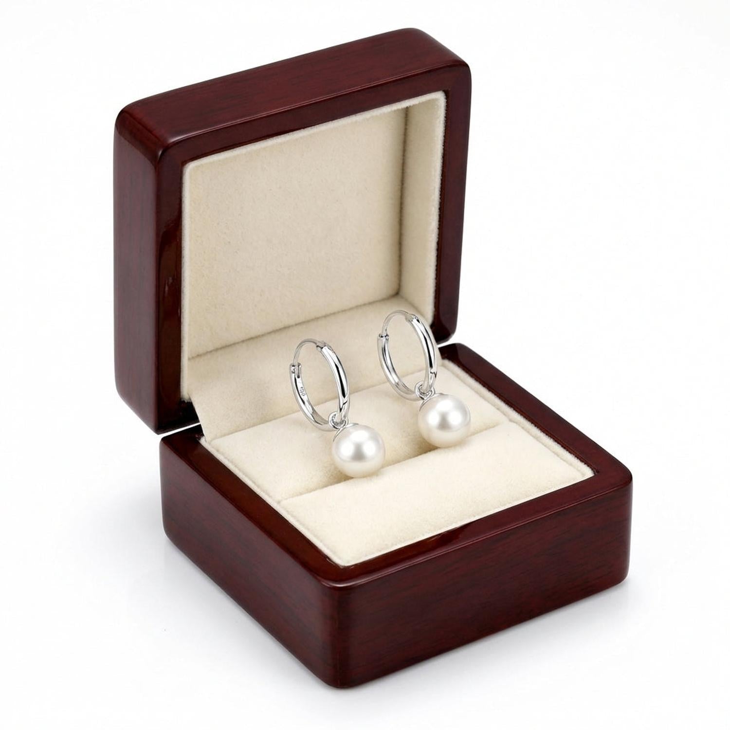 Melchior Jewellery sterling silver pearl hoop earrings displayed in a wooden jewellery box