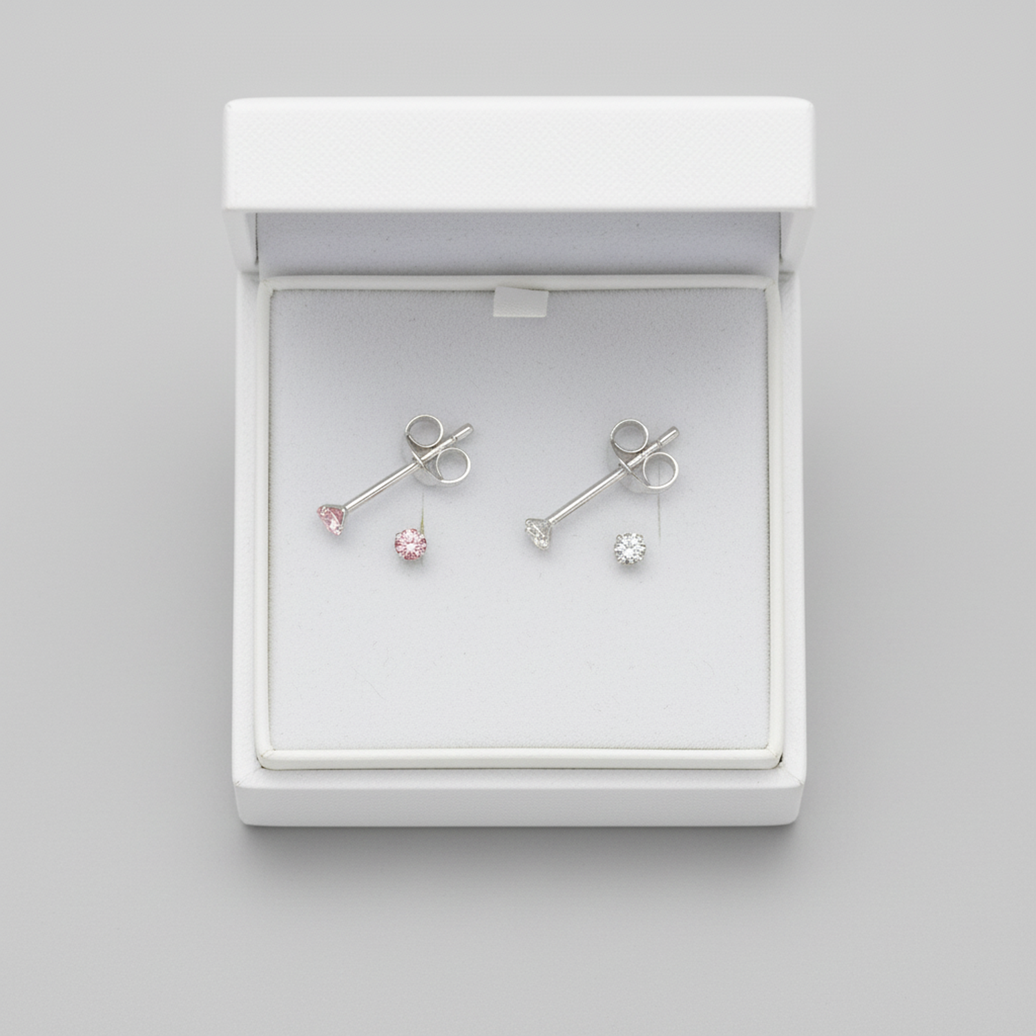 Melchior Jewellery sterling silver pink and clear stud earrings displayed in white jewellery box