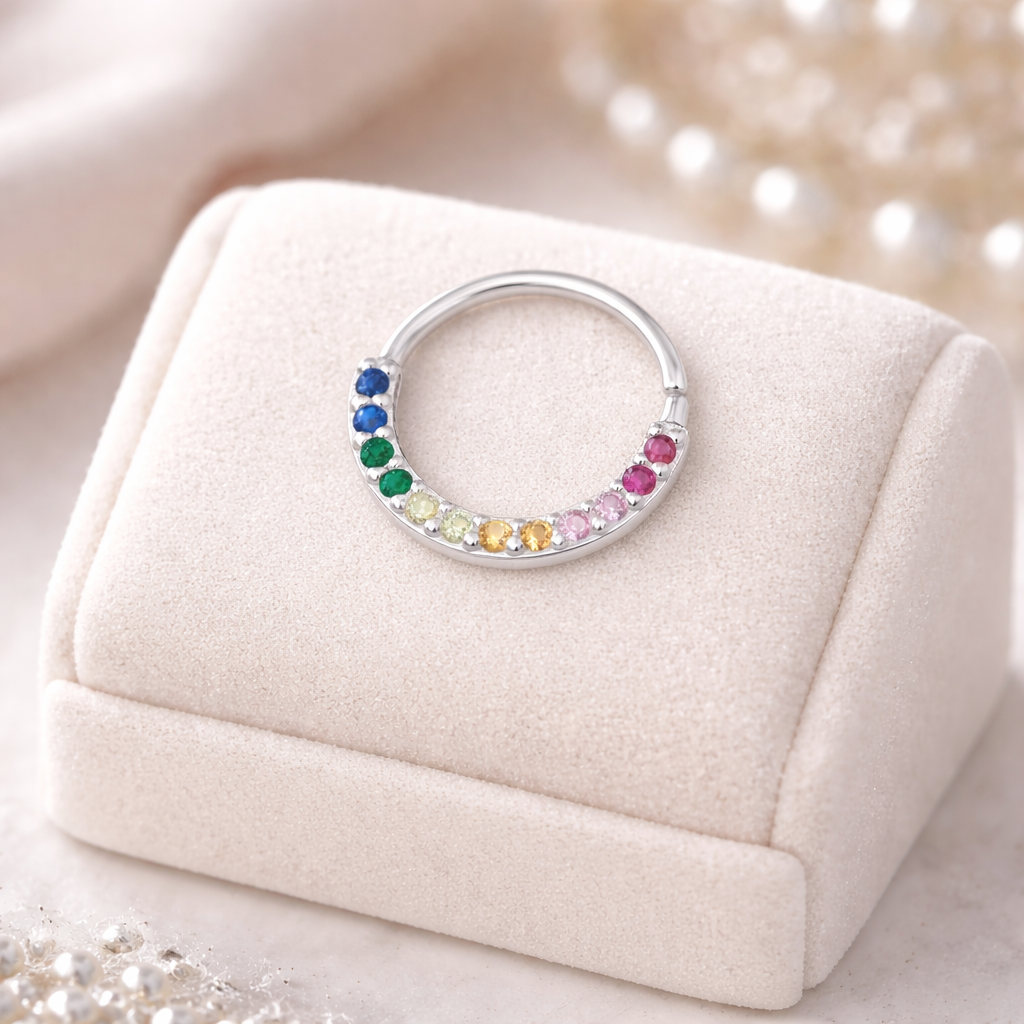 Sterling silver rainbow nose ring from Melchior Jewellery with colourful gemstones in blue green yellow orange and pink